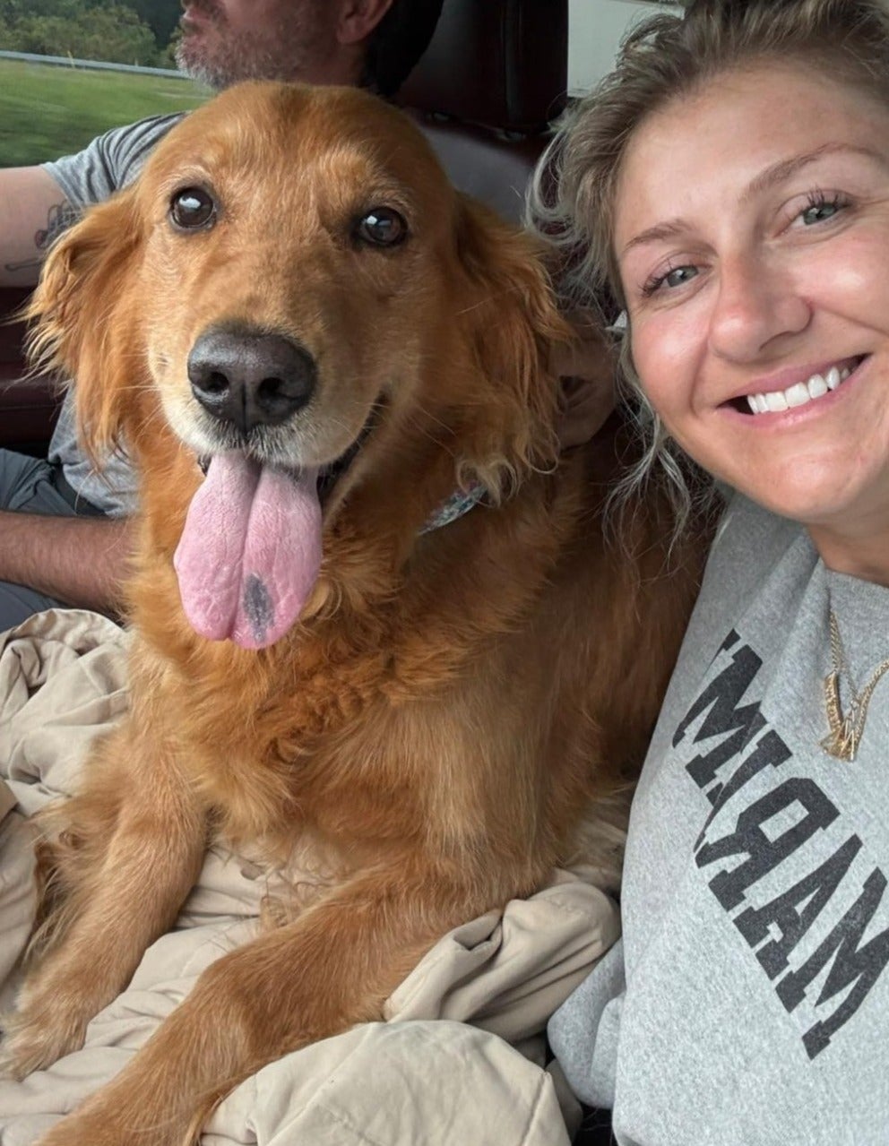 Golden dog resting beside a person